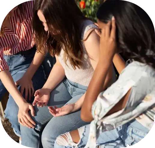 A group of teenagers comforting each other