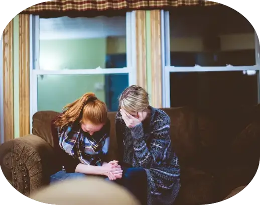 A lady on a lounge consoling a young girl